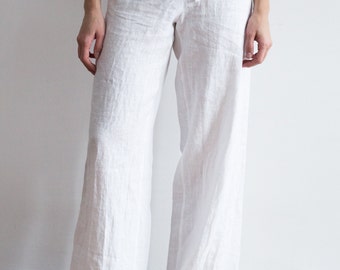 May include: White linen pants with a drawstring waist.