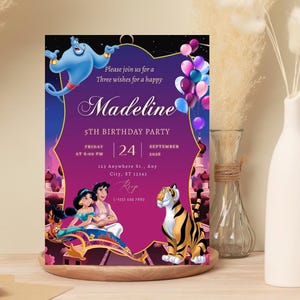 May include: A rectangular birthday party invitation card featuring a purple background with the Genie, Jasmine, Aladdin on a magic carpet, and Rajah the tiger. Text includes Please join us for a Three wishes for a happy Madeline 5TH BIRTHDAY PARTY.