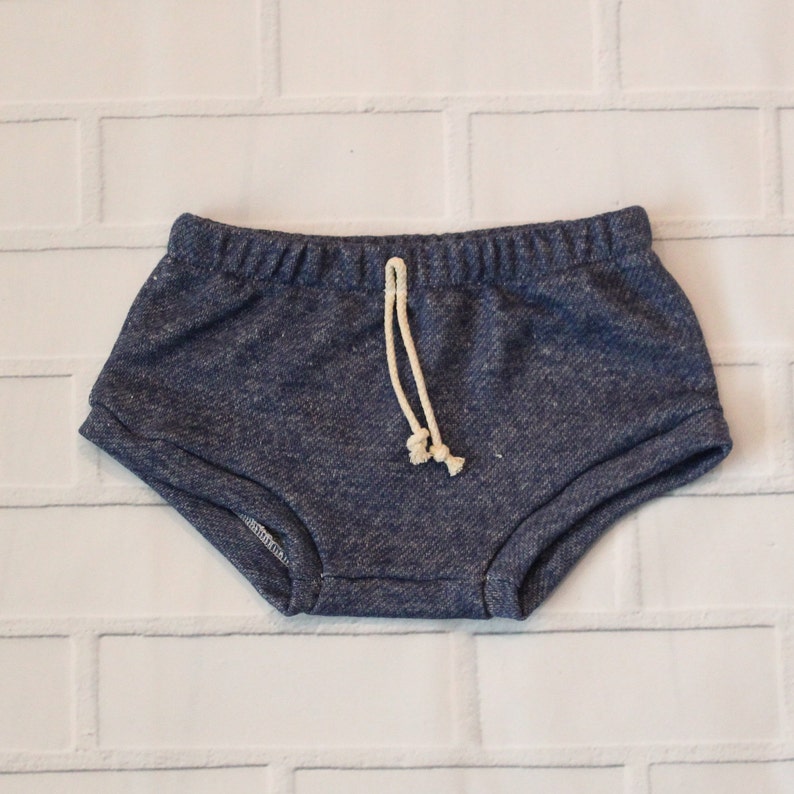 May include: Blue denim shorts with a white drawstring. The shorts have a relaxed fit and are made of a soft, comfortable fabric.