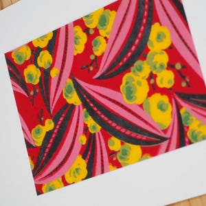 May include: A rectangular art print featuring a vibrant red background with a repeating pattern of stylized yellow flowers and large, elongated leaf shapes in shades of pink and dark charcoal gray with dotted line details throughout the design.