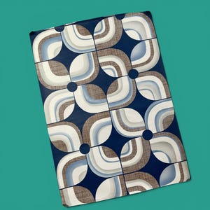 May include: A rectangular fabric with a retro geometric pattern. The design features interlocking shapes in navy blue, brown, white, and light blue. The pattern is arranged in a grid-like formation with dark blue circles.