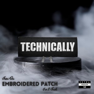 May include: Black iron-on embroidered patch with white text that reads "TECHNICALLY". The patch is 6 inches by 2 inches and is displayed on a black stand.