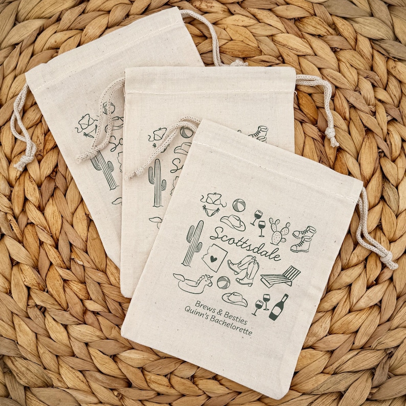 Three drawstring bags (5" x 7") with green printed Scottsdale themed illustrations. The bags offer two lines of custom text and have a variety of Scottsdale illustrations including cowboy hat, cowboy boots, cactus, and pool floats.