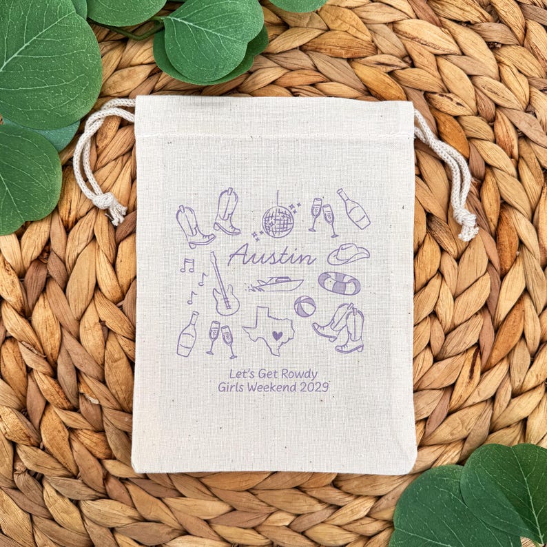 5" x 7" cotton drawstring bags printed with hand drawn Austin icons including cowboy boots, disco ball, boat, and a guitar along with two lines of personalized text.