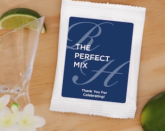May include: A white packet with a blue label that says "The Perfect Mix" with a stylized "B" and "H" on either side of the text. The label also says "Thank You For Celebrating!"