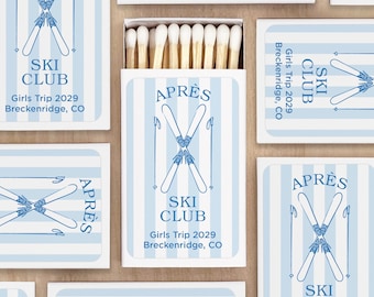 May include: A collection of matchboxes with a light blue and white striped design. Each box features the words "SKI CLUB" and "APRÈS" with crossed skis. The text "Girls Trip 2029 Breckenridge, CO" is also visible.