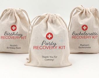 May include: Three beige drawstring bags with red cross symbols and text. The bags are labeled "Birthday Recovery Kit," "Party Recovery Kit," and "Bachelorette Recovery Kit." Additional text includes "Nicole's Birthday Bash," "Thank You for Coming!" and "Madison's Bachelorette."