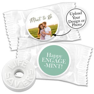 May include: Two white mint tins with personalized labels. One tin has a photo of a couple with the text "Mint to Be". The other tin has the text "Happy ENGAGE -MINT!"