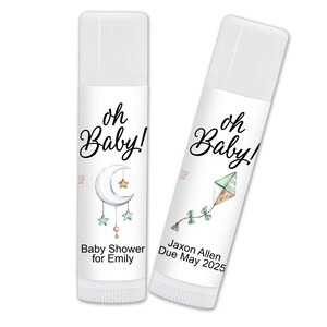 May include: Two white lip balm tubes with labels. One features a crescent moon and stars, the text "oh Baby!" and "Baby Shower for Emily." The other has a kite design, the text "oh Baby!" and "Jaxon Allen Due May 2025."