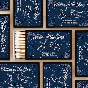 Written in the Stars match boxes with the bride and groom's zodiac sign along with two lines of custom text used as wedding favors or wedding decor.