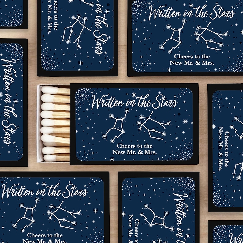 Written in the Stars match boxes with the bride and groom's zodiac sign along with two lines of custom text used as wedding favors or wedding decor.