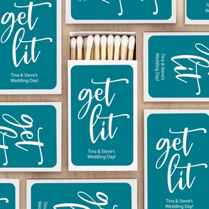 May include: Teal blue matchboxes with white text that reads "get lit" and "Tina & Steve's Wedding Day!"