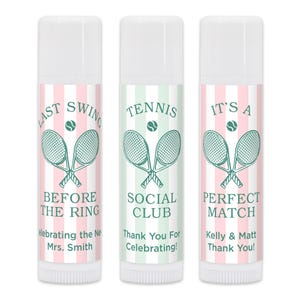 May include: Three lip balm tubes with white lids. Each tube features a tennis-themed design. The first reads "Last Swing Before The Ring", the second "Tennis Social Club", and the third "It's a Perfect Match".