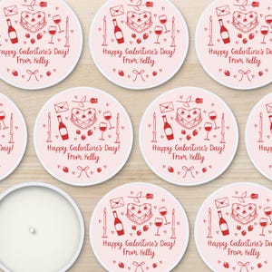 May include: Eight pink and white round stickers with a red heart-shaped cake, wine glass, bottle of wine, and candles. The text on the stickers reads "Happy Galentine's Day! From Kelly".