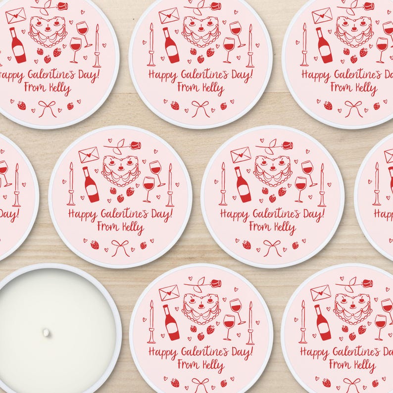 May include: Eight pink and white round stickers with a red heart-shaped cake, wine glass, bottle of wine, and candles. The text on the stickers reads "Happy Galentine's Day! From Kelly".