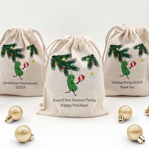 Three mini drawstring bags for the holiday season with a hanging pickle from a Christmas tree branch.  The pickle is holding a pickleball paddle and has two lines of custom text for your event.