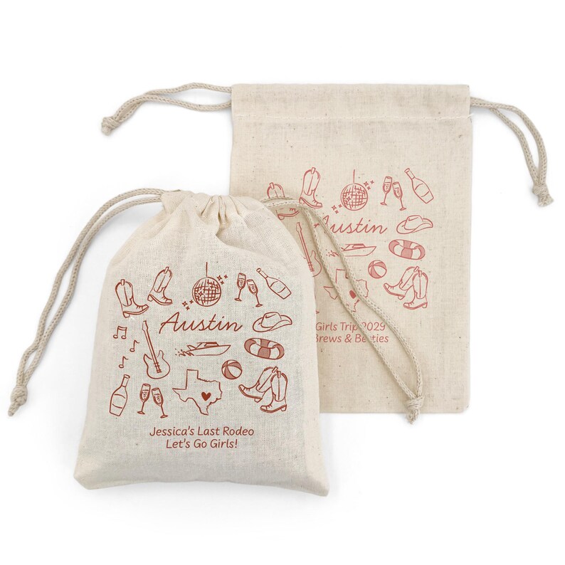 May include: Two beige drawstring bags with red illustrations and text. One bag features the word "Austin", a Texas outline, cowboy boots, and other icons. The text "Jessica's Last Rodeo Let's Go Girls!" is also visible. The second bag has similar illustrations.