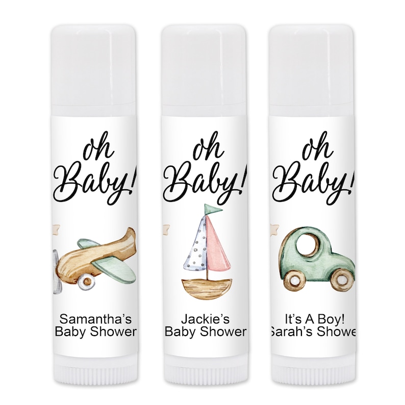 May include: Three white lip balm tubes with "oh Baby!" in script. Each tube features a different watercolor illustration: an airplane, a sailboat, and a car. Text below reads "Samantha's Baby Shower", "Jackie's Baby Shower", and "It's A Boy! Sarah's Showe".