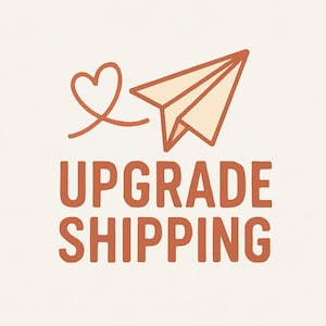 May include: A graphic illustration featuring a paper airplane in beige and brown, with a heart-shaped trail. The words "UPGRADE SHIPPING" are written in brown block letters below the airplane, all set against a cream background.