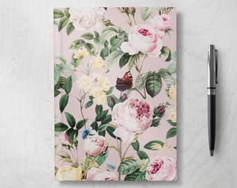 May include: A pink floral notebook with a vintage floral pattern featuring roses, butterflies, and leaves. The notebook has a soft pink background.