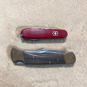 Pair of Buck and Victorinox Pocket Knives