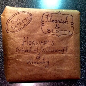 May include: A brown paper package with the text "Owl Express" and "Flourish & Blotts" in a circle. The package also has the text "Hogwarts School of Witchcraft & Wizardry" written on it.