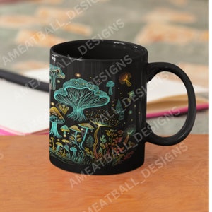 May include: Black ceramic mug with a colorful illustration of mushrooms and plants on a dark background.