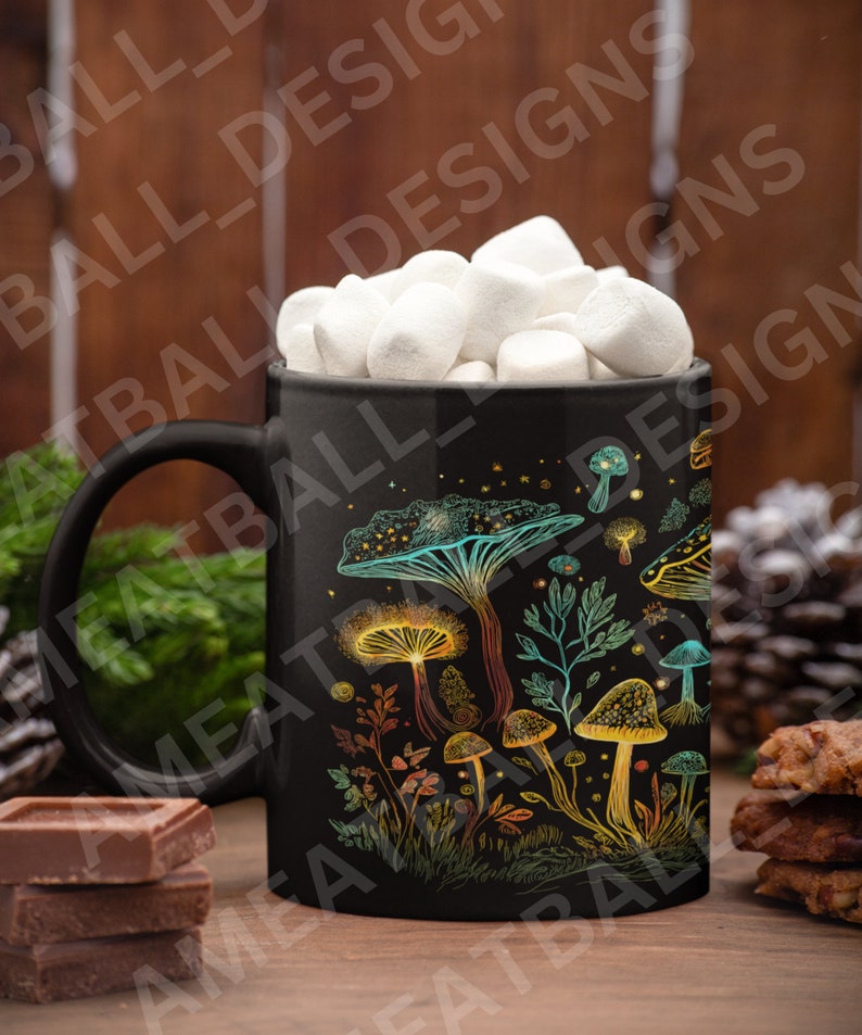 May include: Black ceramic mug with a colorful mushroom design. The mug is filled with white marshmallows and is sitting on a wooden surface.