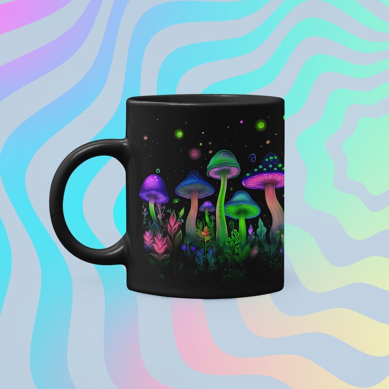 May include: Black ceramic mug with a colorful psychedelic mushroom design. The mushrooms are glowing in the dark with green, purple, and pink colors. The background is black with white stars.