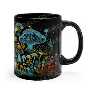 May include: Black ceramic mug with a colorful mushroom design. The mushrooms are outlined in blue and have a variety of colors, including yellow, orange, red, and green. The background is black.