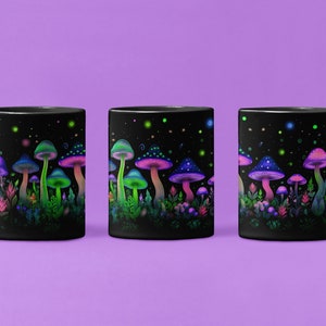May include: Three black mugs with a design of glowing mushrooms and flowers on a black background. The mugs are arranged in a row, with the leftmost mug facing the viewer, the middle mug facing the viewer, and the rightmost mug facing the viewer.