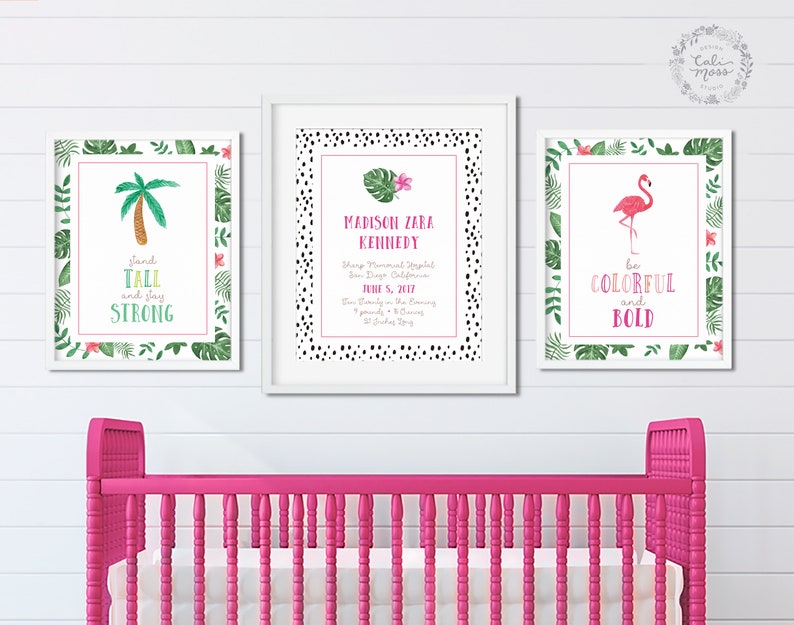 May include: Three framed prints with tropical themes. The first print features a palm tree with the text "stand tall and slay strong". The second print features a flamingo with the text "be colorful and bold". The third print features a floral design with the text "Madison Zara Kennedy, born June 5, 2017".