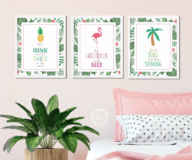 May include: Three framed prints with tropical themes. The first print features a pineapple with the text "wear a crown and be sweet on the inside". The second print features a flamingo with the text "be colorful and bold". The third print features a palm tree with the text "stand tall and stay strong".