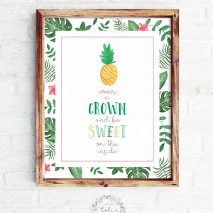 May include: A printable poster with a tropical theme featuring a pineapple and the text "wear a crown and be sweet on the inside". The poster has a green and white border with tropical leaves and flowers.