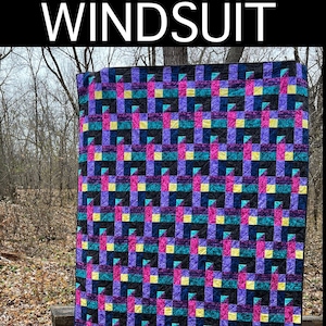 May include: A quilt pattern called "Windsuit" by Karin Pudenz. The pattern includes instructions for baby and throw sizes. The quilt is made with a variety of colorful fabrics, including purple, pink, teal, yellow, and black.
