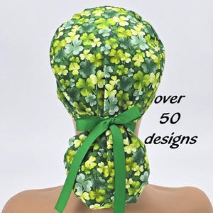 May include: Green surgical scrub hat with a shamrock print. The hat has a green ribbon tie.  over 50 designs