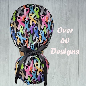 May include: A black scrub hat with a colorful ribbon pattern. The hat has a black tie at the back. Over 60 Designs.