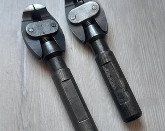 May include: Two black metal bike repair tools with adjustable jaws. The tools have a textured grip and are labeled "SPECIAL" on the handle.