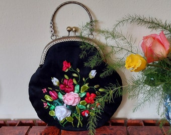 Black embroidered bag with roses.