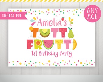 May include: A digital printable sign for a birthday party with a fruit theme. The sign is pink and white with colorful fruit illustrations and the text "Amelia's Tutti Frutti 1st Birthday Party".