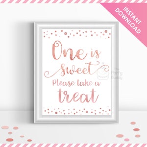 May include: A printable sign with a rose gold background and white text that says "One is sweet. Please take a treat." The sign is decorated with rose gold confetti.