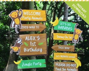 May include: A set of eight jungle-themed party signs with a monkey and banana motif. The signs are made of wood and have a rustic look. The signs include the text: "Welcome Party Animals", "This Way To", "Alex's 1st Birthday", "Jungle Party", "Let's Go Bananas", "Swing On In!", "This Way", "Let's Monkey Around", and "Please Do Not Feed the Animals".