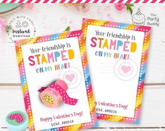May include: Two Valentine's Day cards with rainbow borders and the text "Your friendship is STAMPED ON MY HEART." A pink stamp with a flower design and a pink heart stamp are also visible. The cards say "Happy Valentine's Day! LOVE, AMELIA."
