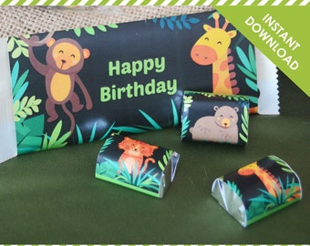 May include: Printable jungle-themed candy bar wrappers with a black background and colorful animal illustrations. The wrappers feature a monkey, giraffe, tiger, and bear. The text "Happy Birthday" is printed on the wrapper.