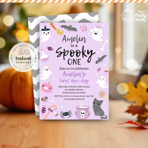 May include: A lavender Halloween-themed invitation with the text "Amelia is a Spooky One" and "First Boo-day." The design includes ghosts, bats, a black cat, and a jack-o'-lantern. The invitation also includes event details.