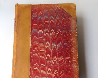 May include: A vintage book with a marbled cover in shades of red, white, and blue. The cover is bound in leather with a decorative pattern.