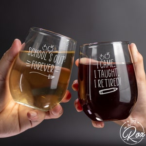 May include: Two wine glasses with etched sayings. The first glass says "School's Out =Forever=". The second glass says "I Came. I Taught. I Retired!"