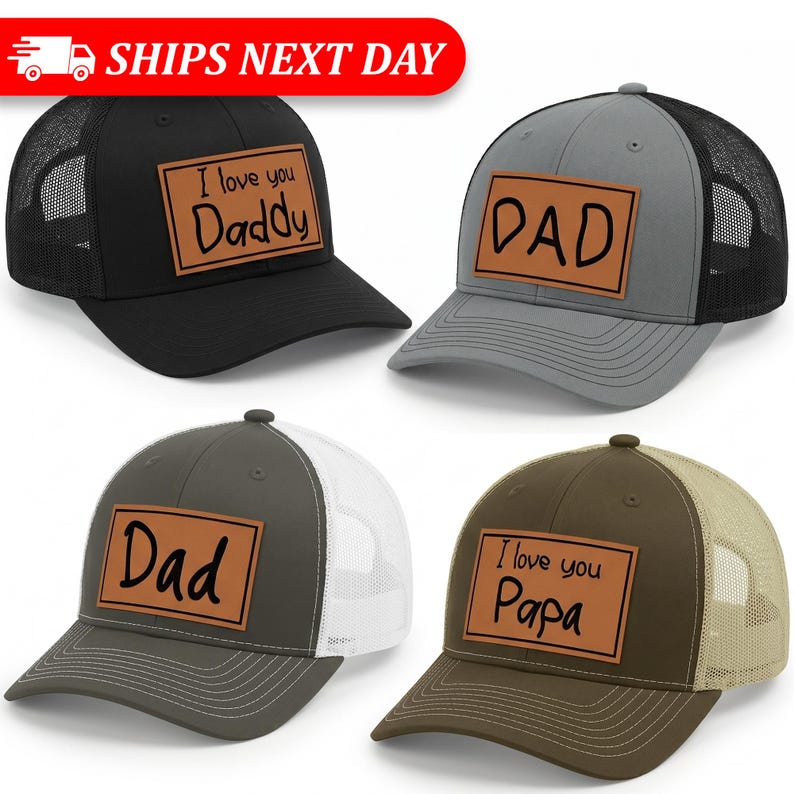 May include: Four trucker hats in black, gray, olive green, and brown. Each hat has a mesh back and a rectangular patch with text: "I love you Daddy", "DAD", "Dad", and "I love you Papa".