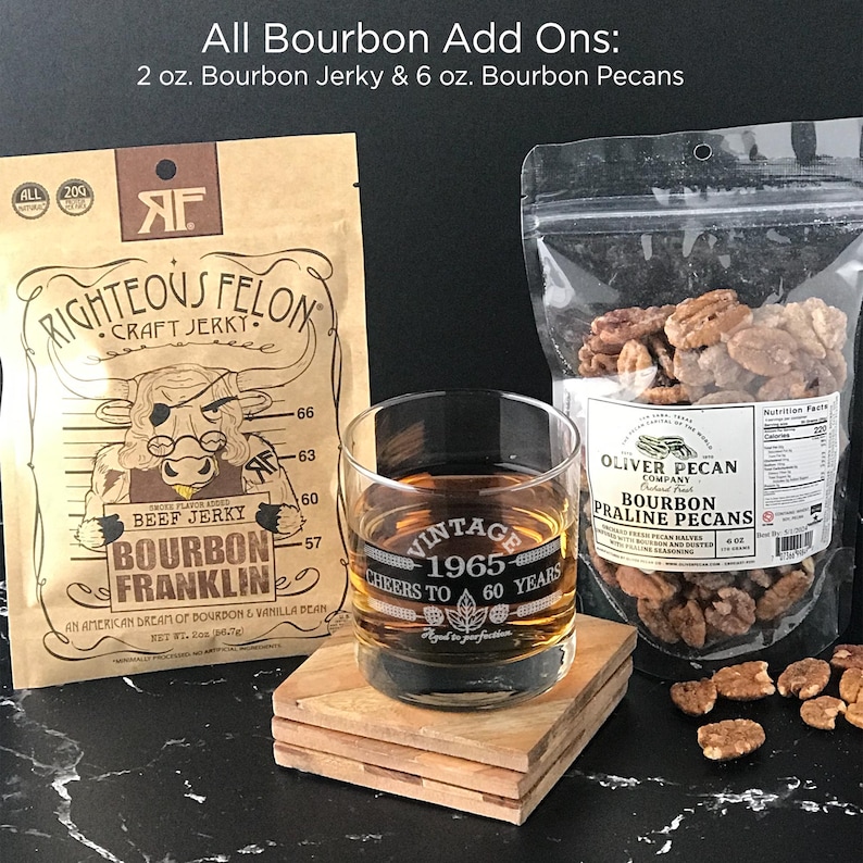 May include: A set of bourbon-flavored snacks, including a bag of bourbon jerky with a cartoon bull on the packaging, a bag of bourbon pecan pralines, and a glass with the text "Vintage 1965 Cheers to 60 Years".