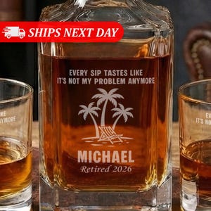 May include: A square glass decanter filled with amber liquid, featuring etched text and a tropical scene with palm trees and a beach chair. The text reads "EVERY SIP TASTES LIKE IT'S NOT MY PROBLEM ANYMORE" and "MICHAEL Retired 2026".